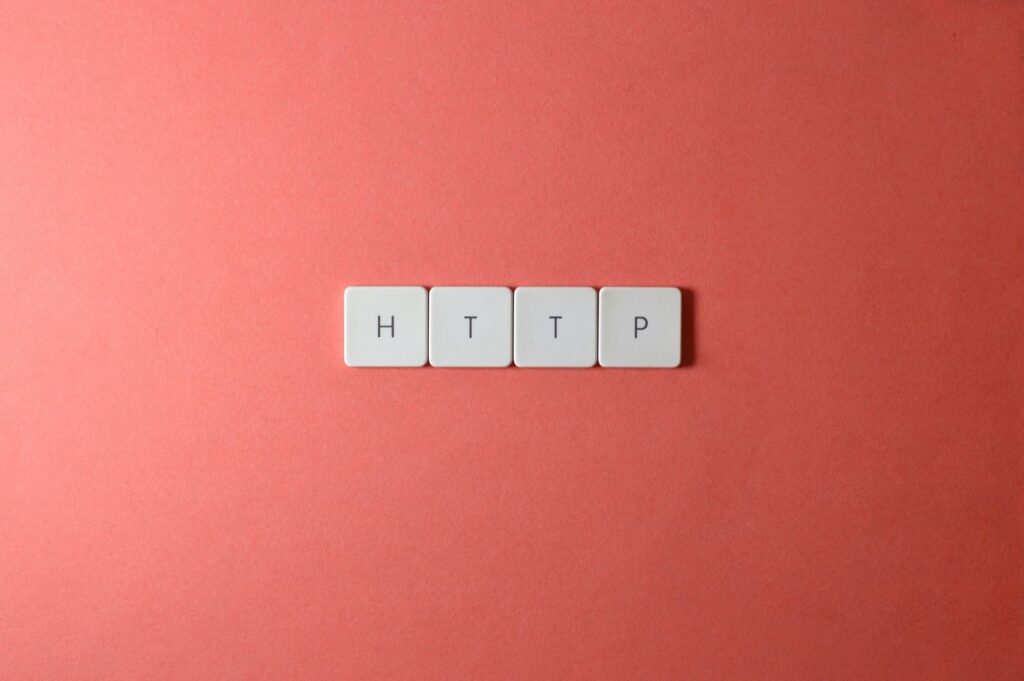 HTTP spelled with keyboard keys on a pink background, minimalist style.