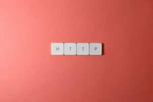 HTTP spelled with keyboard keys on a pink background, minimalist style.